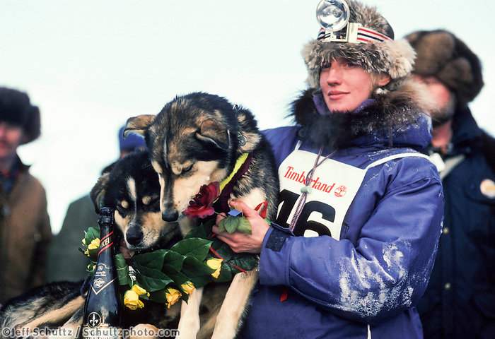 Libby Riddles with dogs Axle and Dugan after taking first place at the 1985 Iditarod dog sled race. Braving 1,000 miles across the Alaskan wilderness, Libby was the first woman to win the prestigious arctic chase.